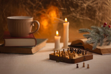 Cozy vintage composition, bringing a sense of warmth and festivity. Chessboard on the table among...
