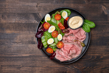 Lunch dish Roast beef with spinach salad and quail eggs healthy lunch keto diet food	