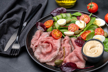 Lunch dish Roast beef with spinach salad and quail eggs healthy lunch keto diet food	