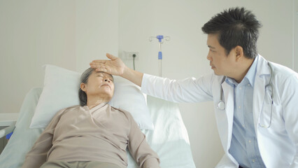 Obraz premium Portrait of Asian doctor check up body of sick old senior elderly patient on bed in hospital in medical and healthcare treatment at nursing home. People lifestyle