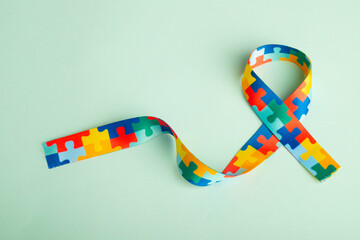World Autism awareness and pride day with Puzzle pattern ribbon - obrazy, fototapety, plakaty