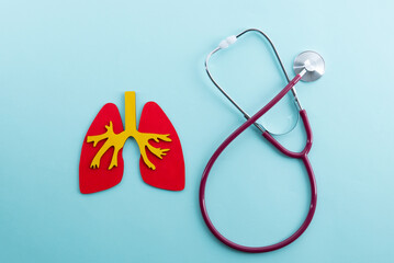 mockup lungs and stethoscope lies on a blue background - obrazy, fototapety, plakaty