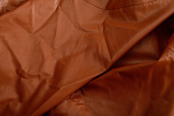 Artificial leather background and texture. wrinkled brown leather.