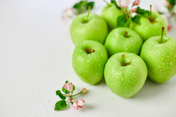 Flat lay Apple flowers and ripe green apples on a white background, Fruits and flowers, sping concept. Top view