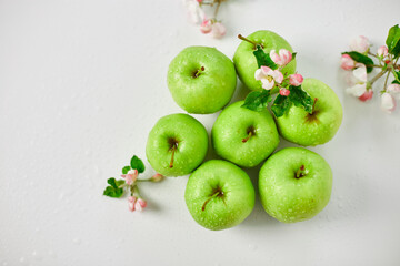 Flat lay Apple flowers and ripe green apples on a white background, Fruits and flowers, sping concept. Top view