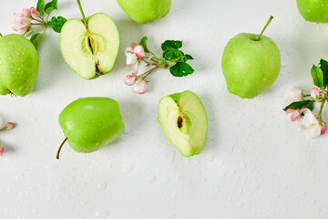 Flat lay Apple flowers and ripe green apples on a white background, Fruits and flowers, sping concept. Top view