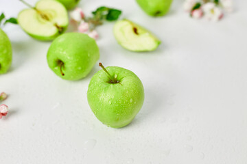Flat lay Apple flowers and ripe green apples on a white background, Fruits and flowers, sping concept. Top view
