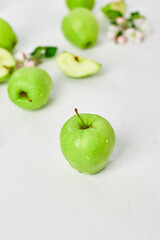 Flat lay Apple flowers and ripe green apples on a white background, Fruits and flowers, sping concept. Top view
