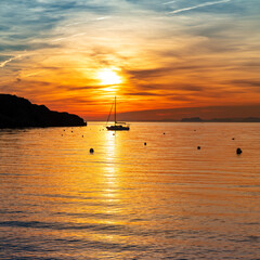 Sailing at sunset with mountains in mediterranean sea