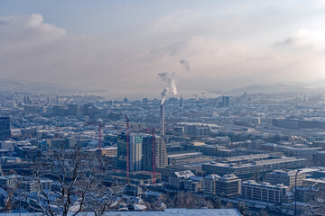 Naklejka premium Aerial view over snow covered City of Zürich with Lake Zürich in the background on a blue cloudy late autumn day. Photo taken December 11th, 2022, Zurich, Switzerland.