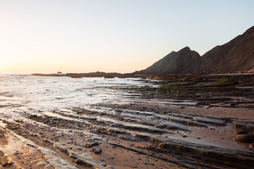 Fototapeta na wymiar Dusk on Rocks and Sea at Amoreira Beach; Algarve; Portugal