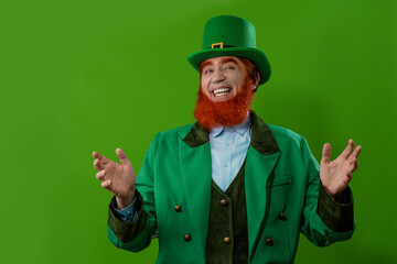 Leprechaun elf on St. Patrick's Day. Cheerful character Irish leprechaun for advertising with a red...