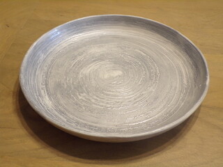 dish with gray vortex pattern on top of a table