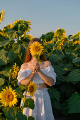 The girl covers her face with a sunflower. Girl in a field of sunflowers.
Inflatable pink flamingo against the blue sky.