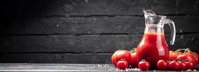 Fototapeta premium Juice from ripe tomatoes on the table. 