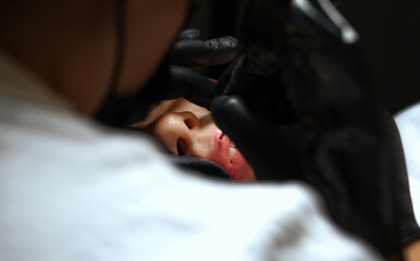 Makeup artist making lip permanent powder makeup