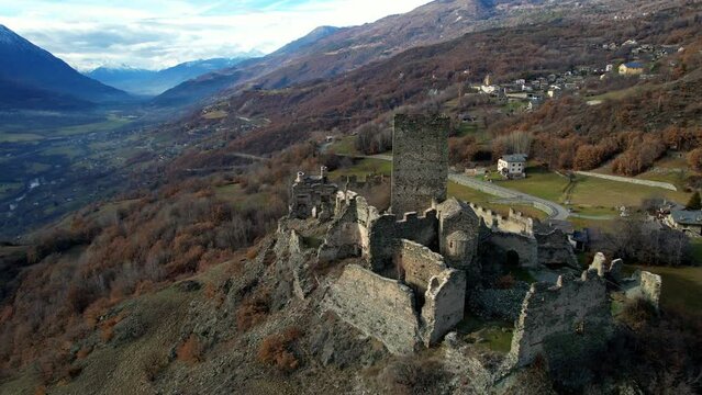 Medieval impressive castle Cly surrouded by Alps mountains in Valle d'aosta, aerial drone view