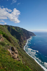 Obraz premium Cliffs, Atlantic Occean and blue sky on sunny day, Madeira, Portugal