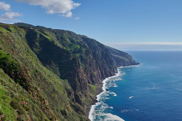 Fototapeta premium Cliffs, Atlantic Occean and blue sky on sunny day, Madeira, Portugal