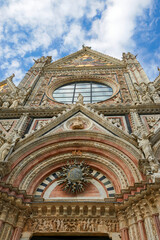 Facade fragment of the city cathedral of Siena on a sunny day