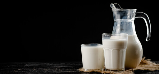 Fresh homemade milk on the table in a glass. 