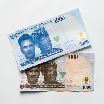 The new and old Nigerian 1000 Naira notes on a white surface, a comparison of Nigeria's new and old currency