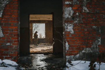 The Ukrainian military stands in the middle of a destroyed and burned Red brick building in eastern Ukraine