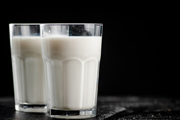 A glass of fresh milk on a stone board. 