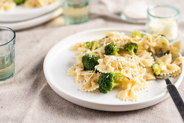 Savory farfalle pasta with walnuts pesto, broccoli and parmesan cheese