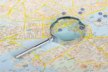 Magnifying glass, lens on map. Searching location, geography concept. High quality photo