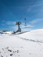 Snow covered pine trees on the background of mountain peaks. Panoramic view of the winter.
