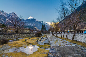 Himalaya mountain landscape in early winter morning. Trekking route among houses in Chhairo (Chairo) village, Annapurna circuit / Jomsom trek, Nepal.