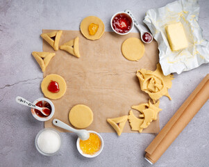 Fototapeta premium Dough, Jam, Sugar, Butter, Rolling Pin on Gray Stone Table. Purim Celebration, Jewish Carnival Holiday Concept.