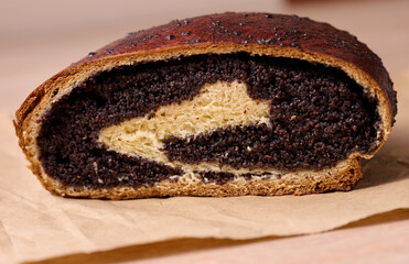 Baked roll with poppy seeds on the table