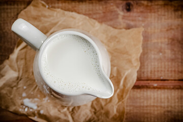 A jug of fresh milk on the table. 