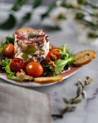 Chicken salad on a bed of mixed greens, grape tomatoes, and toasted walnuts. Garnished with dill and dusted with hibiscus petal powder. 