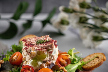 Chicken salad on a bed of mixed greens, grape tomatoes, and toasted walnuts. Garnished with dill and dusted with hibiscus petal powder. 