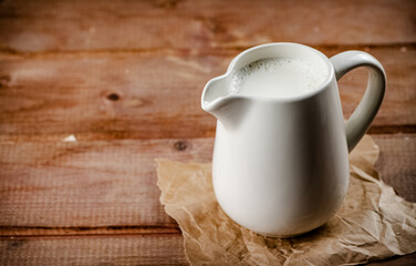 A jug of fresh milk on the table. 
