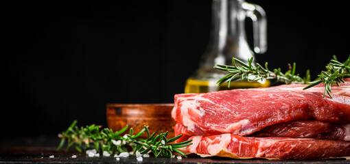 A pile of raw pork steak on the table. 