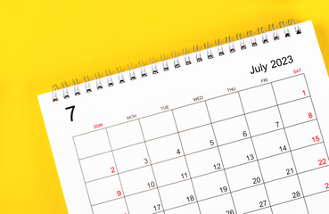 The July 2023 Monthly desk calendar for 2023 year on yellow background.