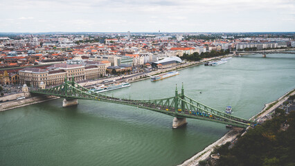 Fototapeta premium Szabadsag hid, Freedom or Liberty Bridge. Aerial view from a hills in Budapest. Connecting Buda and Pest across the River Danube. Begining autumn colors.