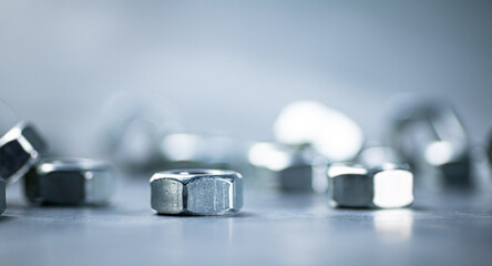 Working tool. Metal nuts on the table. 