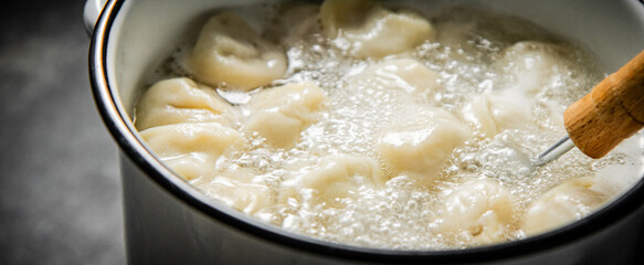 Dumplings are boiled in a saucepan in boiling water. 
