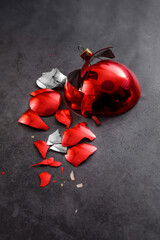 broken red christmas ball on a dark background
