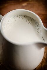 A jug of fresh milk on the table. 