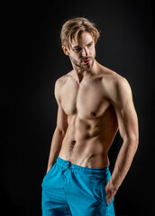 Fototapeta na wymiar man with muscular abs in studio. sporty muscular man with abs muscles. photo of man