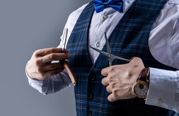 man with barbershop scissors and blade, copy space. barber man in barbershop studio.