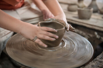 Kid hands make clay pot to jar or vase in Koh Kret, Nonthaburi