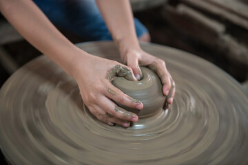 Closeup hands make clay pot to jar or vase in Koh Kret, Nonthaburi