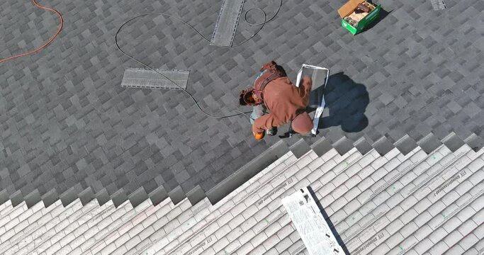 Roof of house was installed with new shingles by construction worker